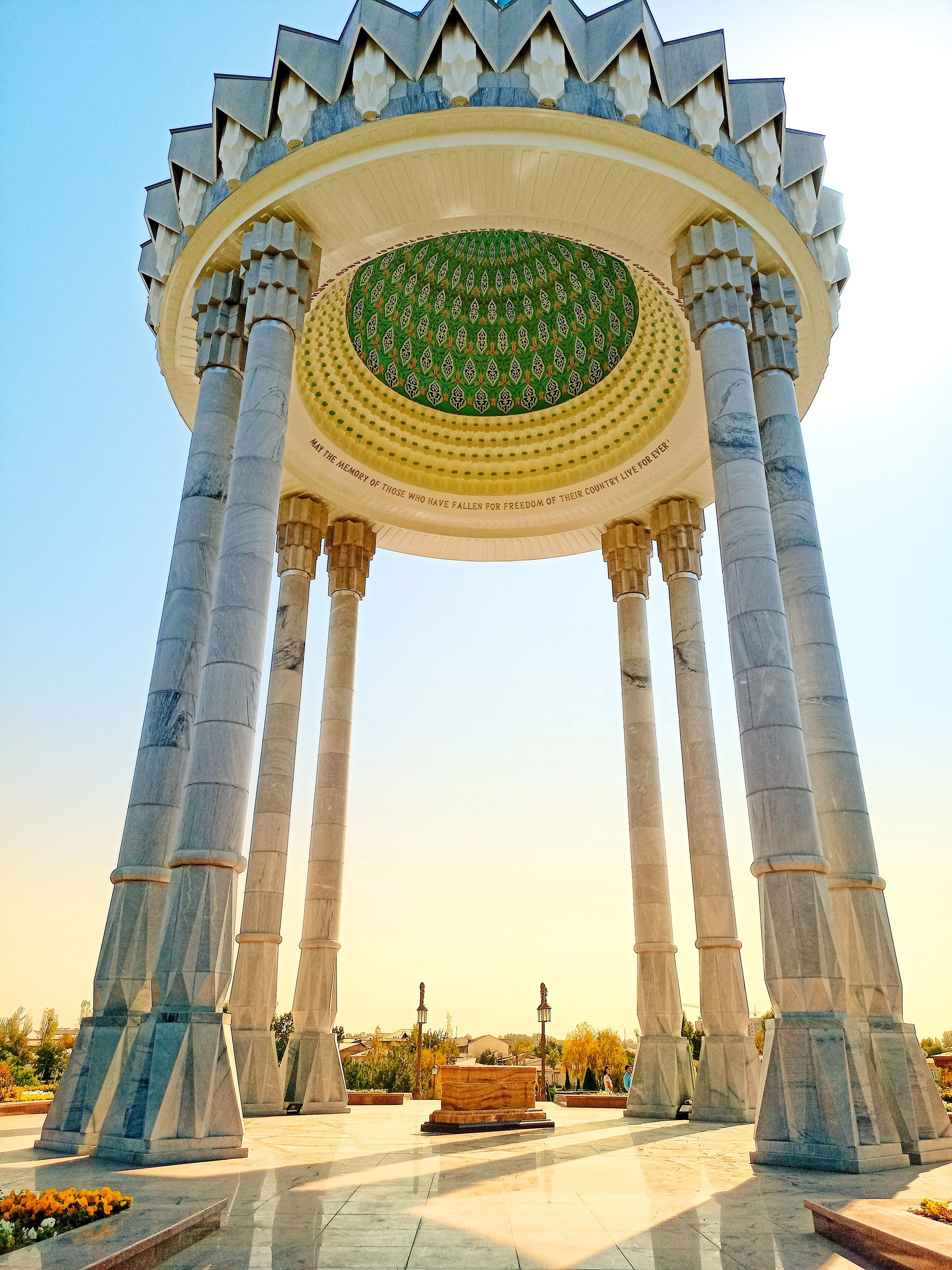 A marble rotunda with slender columns against a clear sky