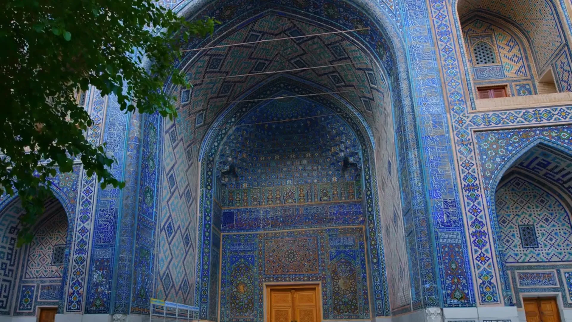 Intricate blue tilework on a historic portal in Samarkand