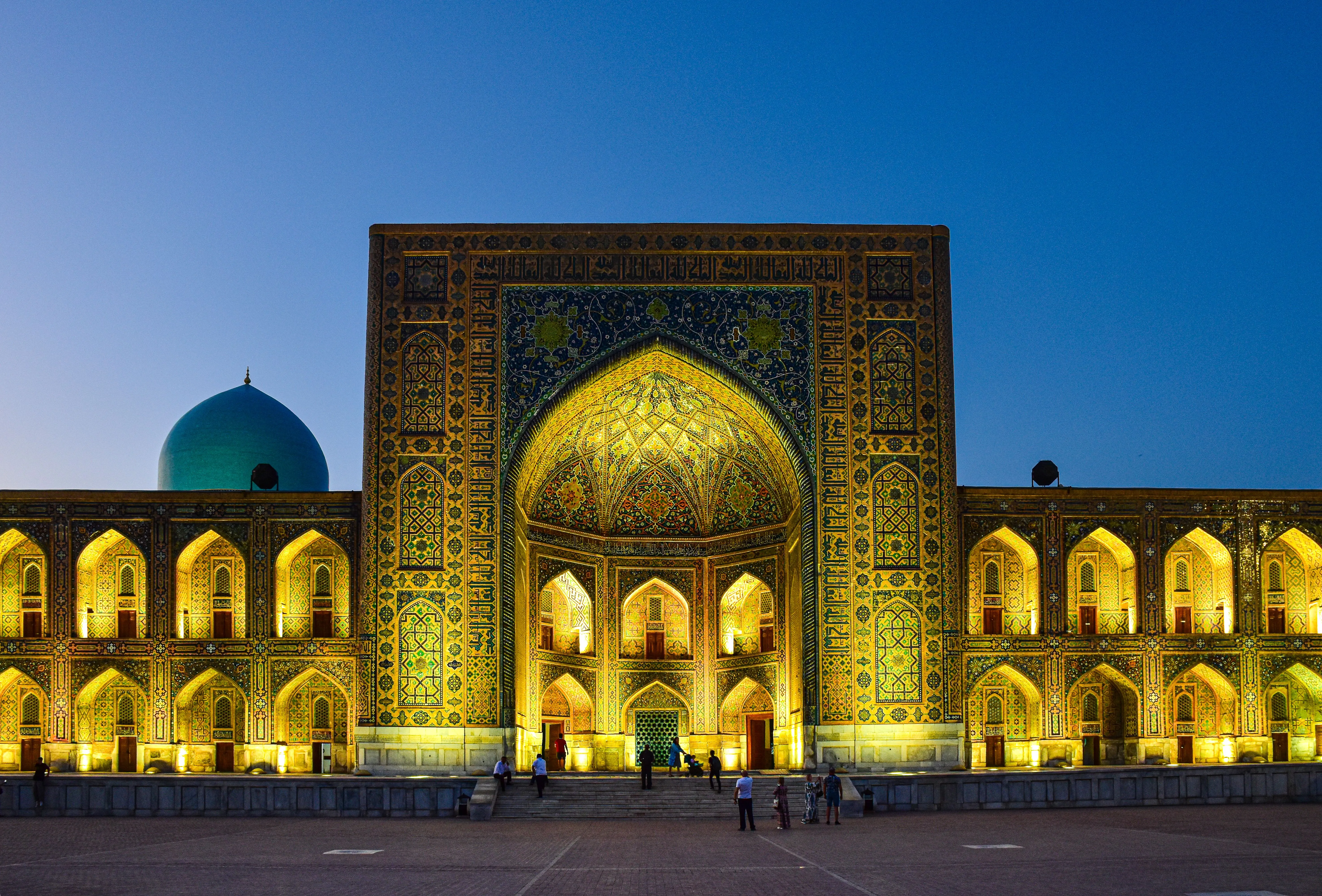 The floodlit Tilya-Kori madrasa at the Registan in Samarkand at dusk